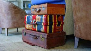 Suitcases piled atop eachother