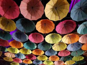Many colorful umbrellas upside down