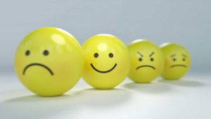 Four smiley faces with different expressions